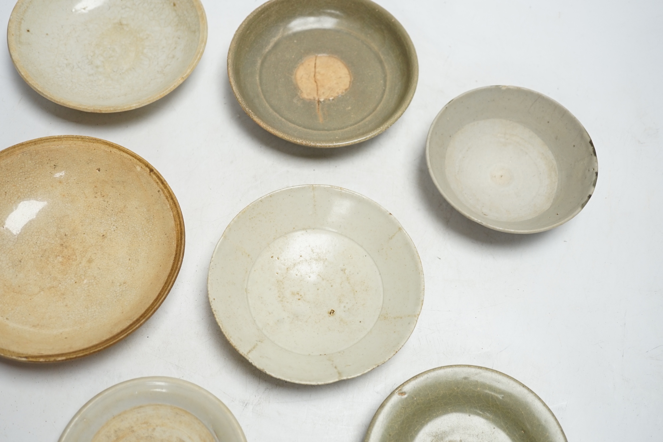 A group of seven Chinese Ding type, qingbai and celadon dishes, Song-Yuan dynasty, largest 15.5cm